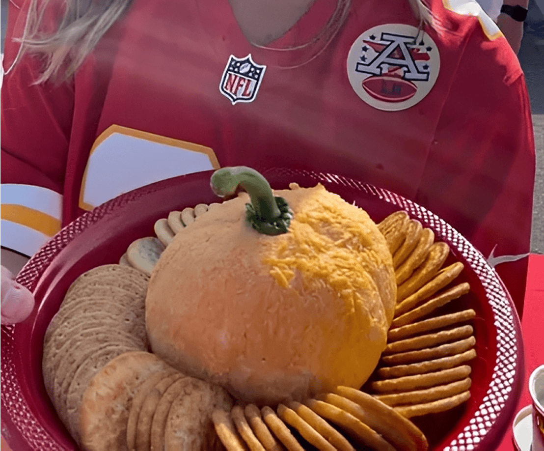 Cheese ball with crackers on red plate.