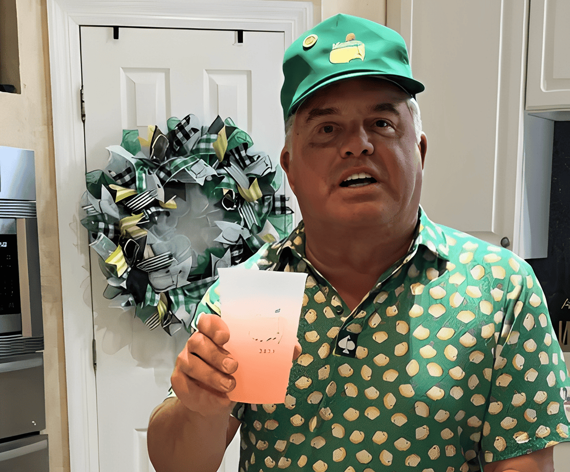 Man holding a cup in decorated kitchen.