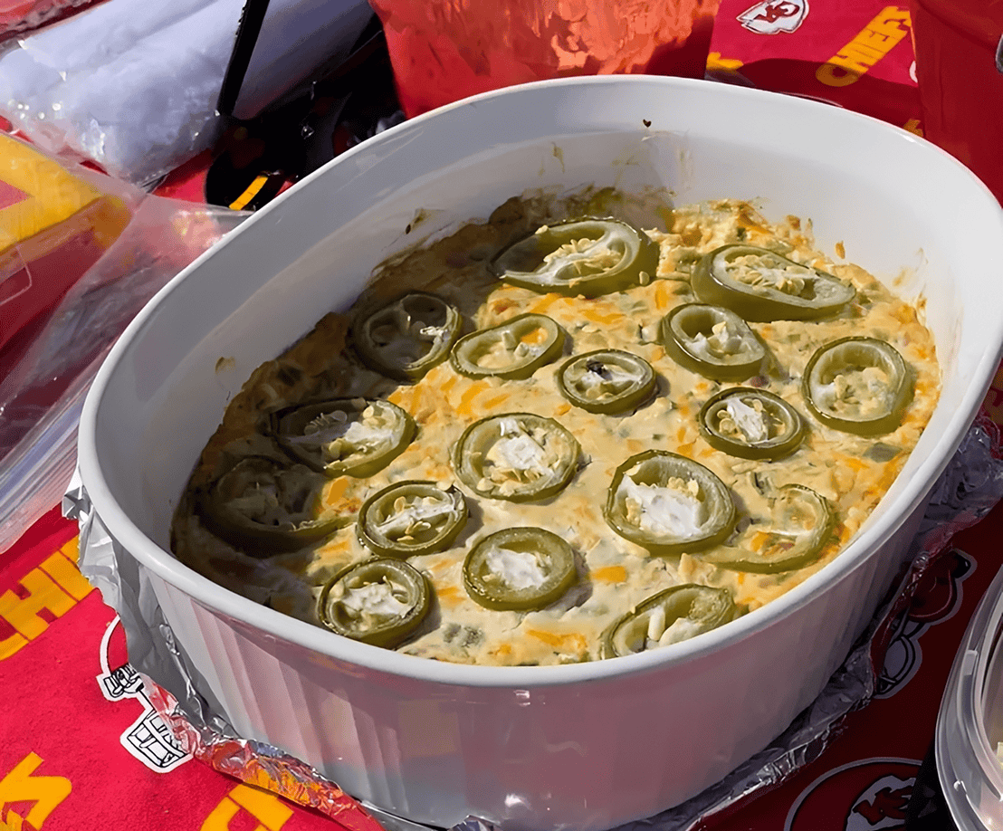 Baked dip topped with sliced jalapeños.