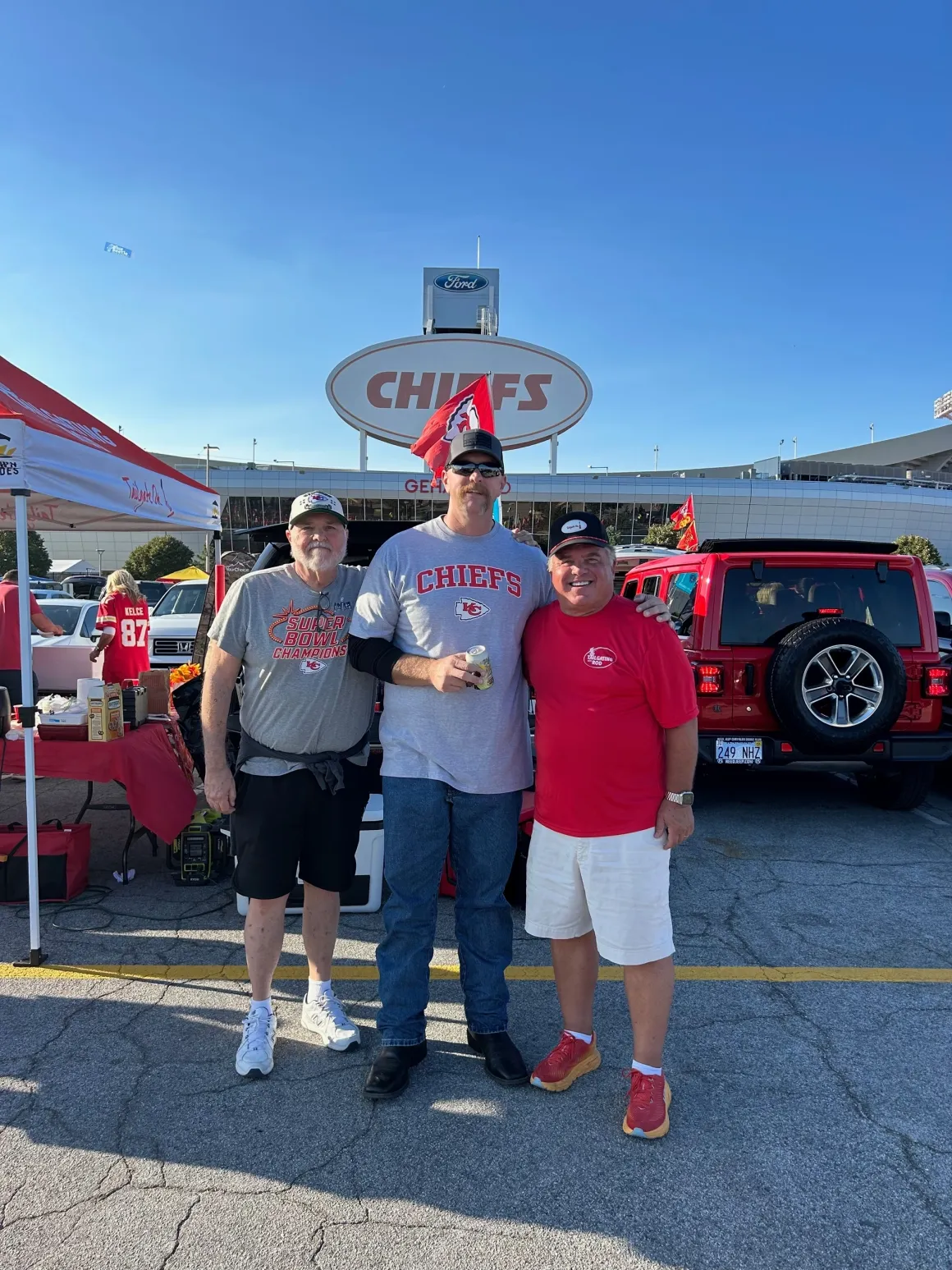 Three men tailgating at Chiefs game.