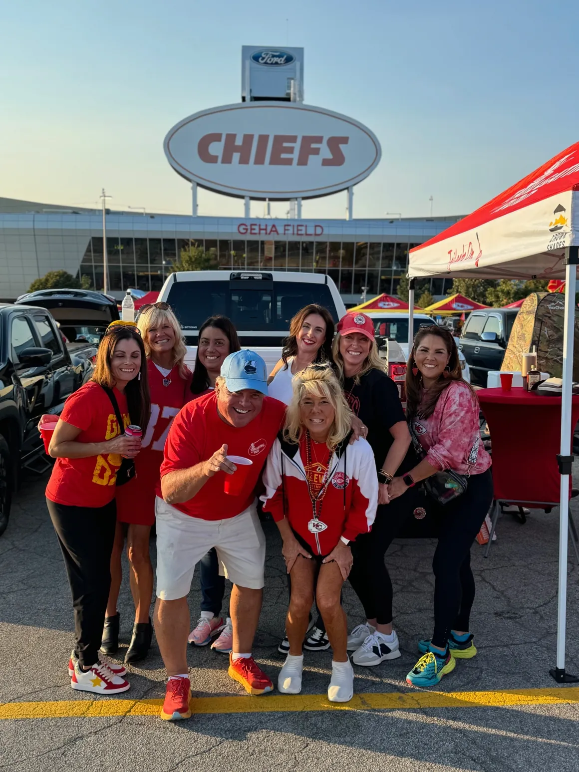 Group tailgating at Chiefs stadium entrance.