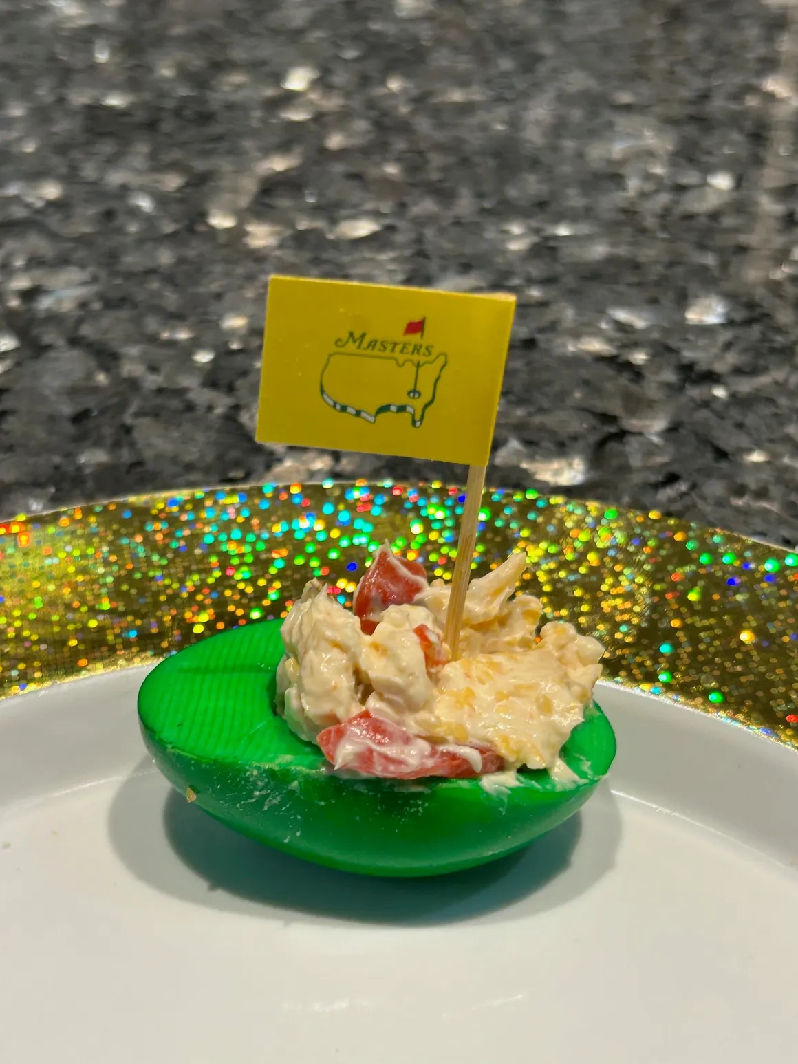 Green deviled egg with Masters flag decoration.