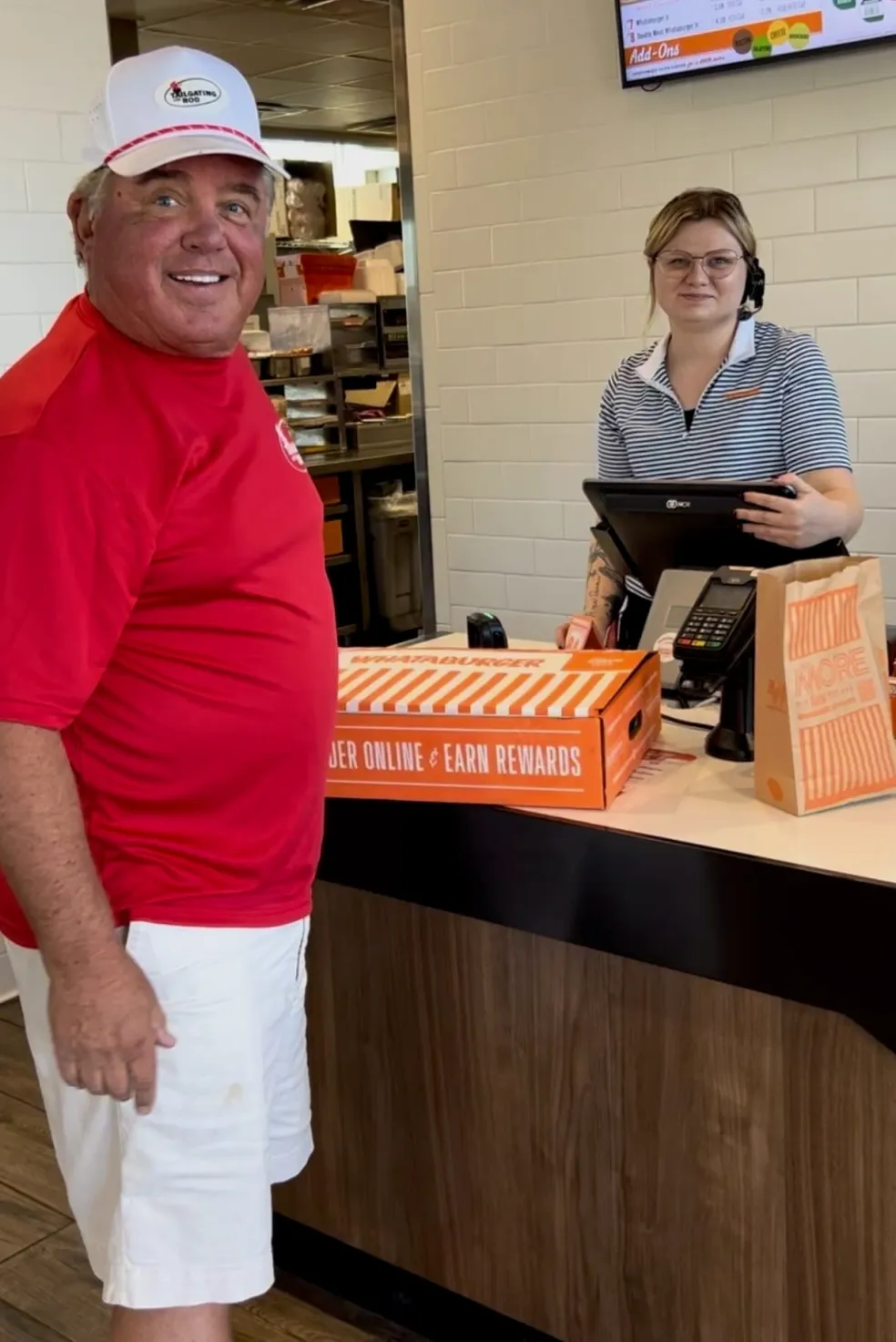 Man and cashier at fast food counter.