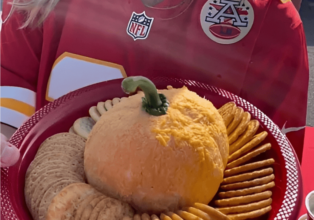 Cheese ball with crackers on red plate.
