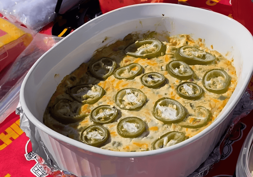 Baked dip topped with sliced jalapeños.