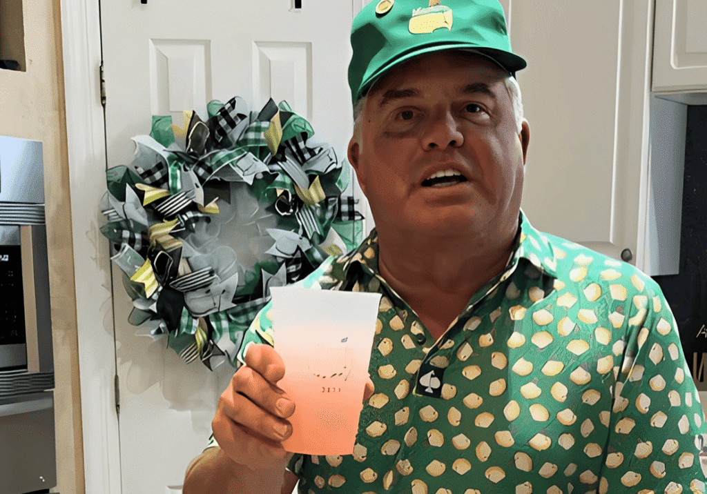 Man holding a cup in decorated kitchen.