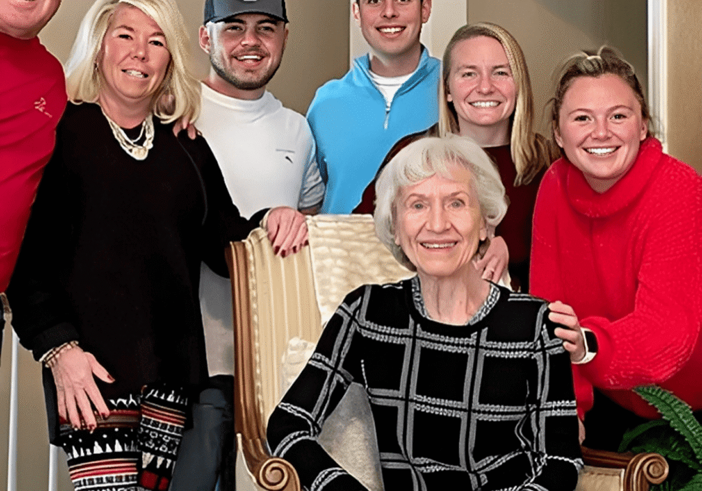 Group photo with an older woman seated.